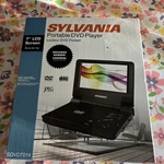 Nos Sylvania SDVD7014 Black 7" Portable Player With Swivel Screen + Charger Open. Price: $49.99.